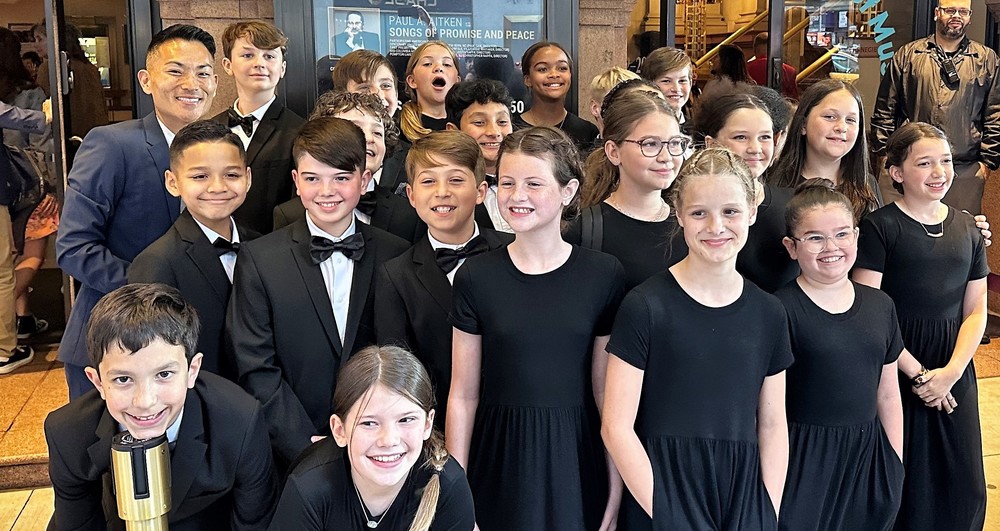 Franklin Elementary students and music director pose for picture outside of Carnegie Hall before their performance