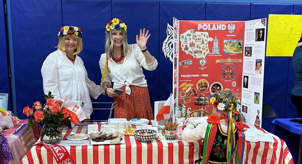 Washington parents and child in traditional dress host Poland table at Multicultural Festival on April 23.