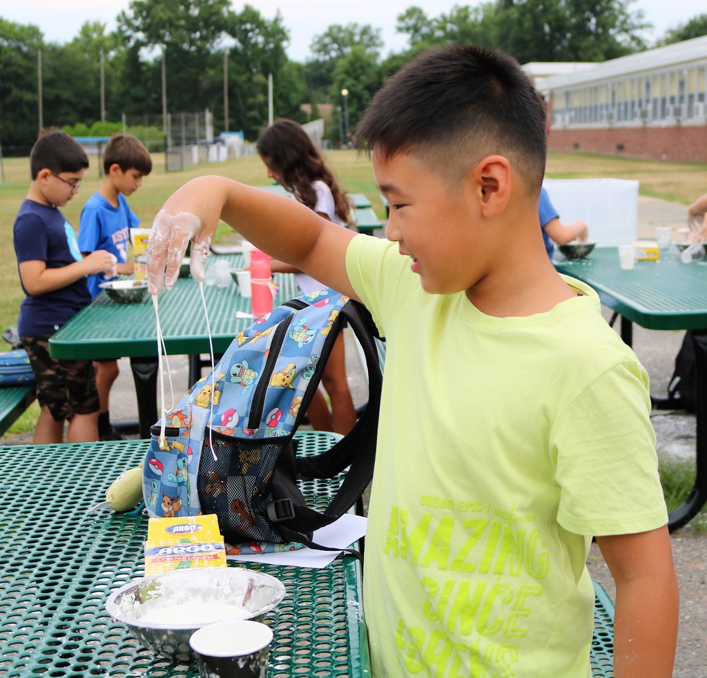 STEM campers enjoy exploring scientific concepts while making slime during the new STEM Camp workshop, “Mind Blowing Experiments” with Edison science teacher David Parke.