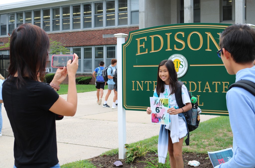 Edison parent takes picture of 6th grader in front of school sign