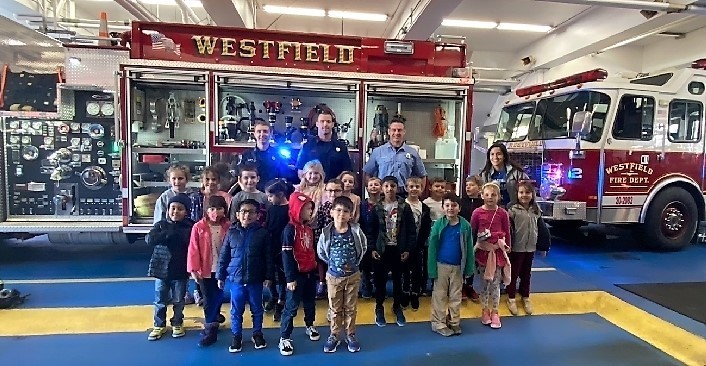 McKinley 1st graders pose for a picture with Westfield firefighters