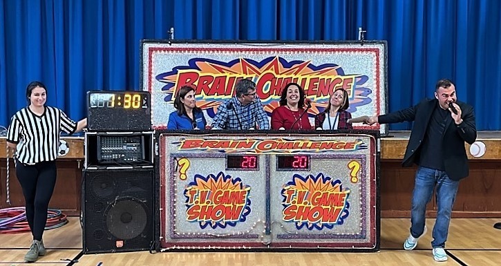 Jefferson teachers in "Brain Challenge" booth with announcers