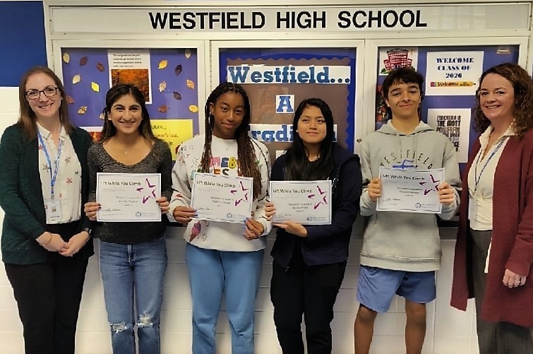 Four WHS students hold award certificates, pictured with WHS principal and director of counseling 