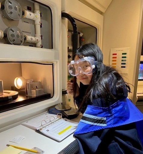 Wilson 5th grader wears lab goggles during field trip 