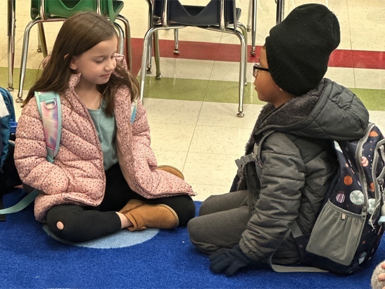 Two Lincoln Kindergartners exchange kindnesses during circle time