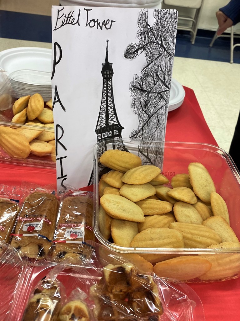 French breakfast items on a table with an Eiffel Tower drawing