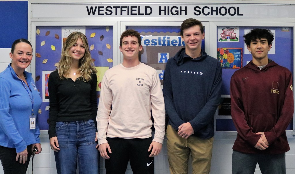 Principal Mary Asfendis poses with four of five WHS students who earned perfect scores on recent ACT-SAT subject area tests.