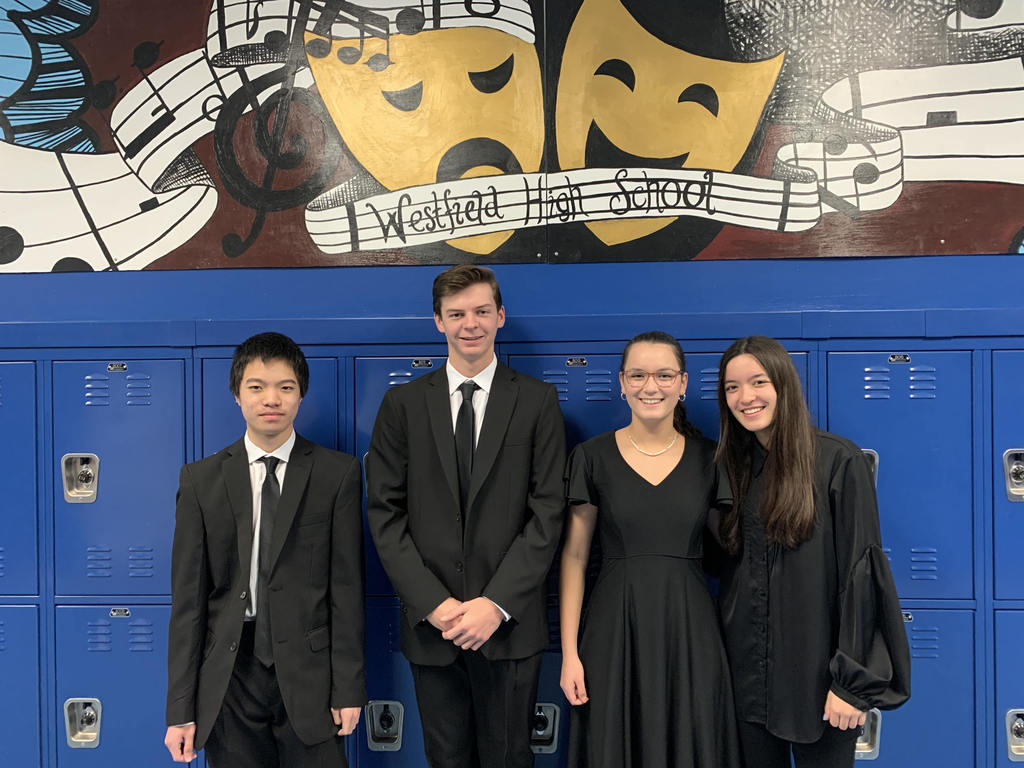 4 WHS student musicians pose for picture after being selected to perform with Region II band.