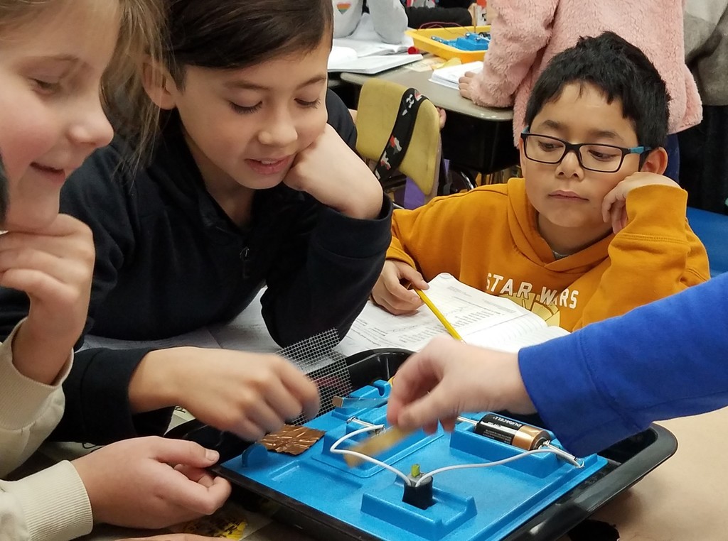 McKinley 4th graders work with circuit board during electricity unit