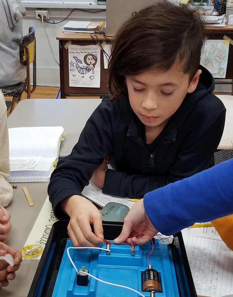 McKinley 4th grader works with circuit board during electricity unit