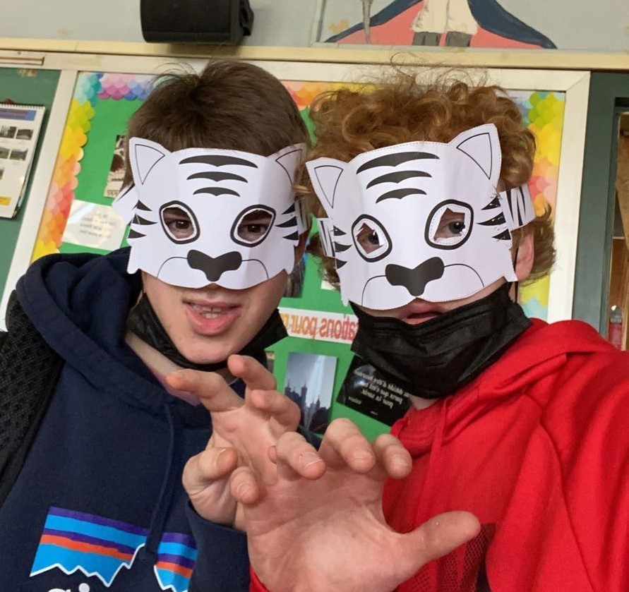 Two WHS mandarin students wear tiger masks