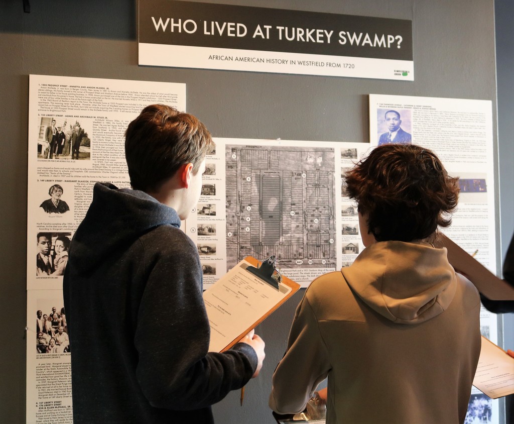 Two middle school students examine museum exhibit