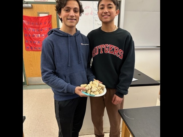 Two WHS students hold plate of fermented food as part of science unit