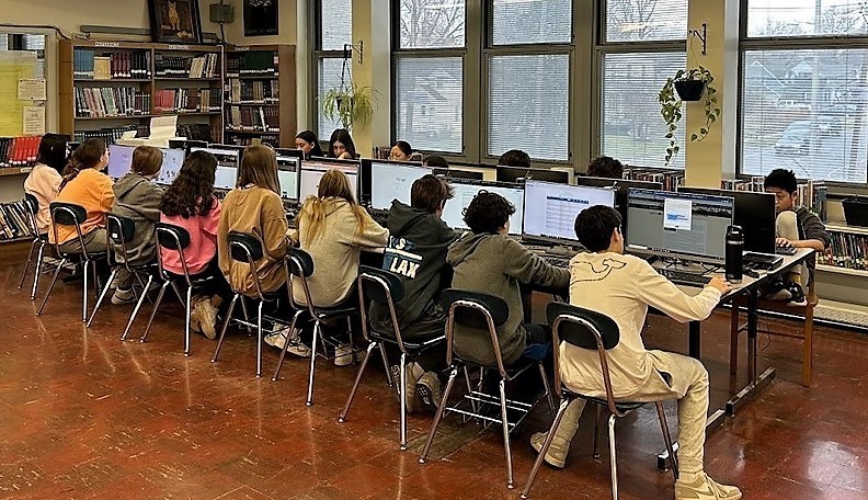Students seated in line of computers