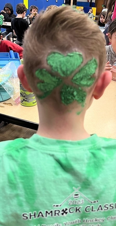 Back of student's head with green shamrock
