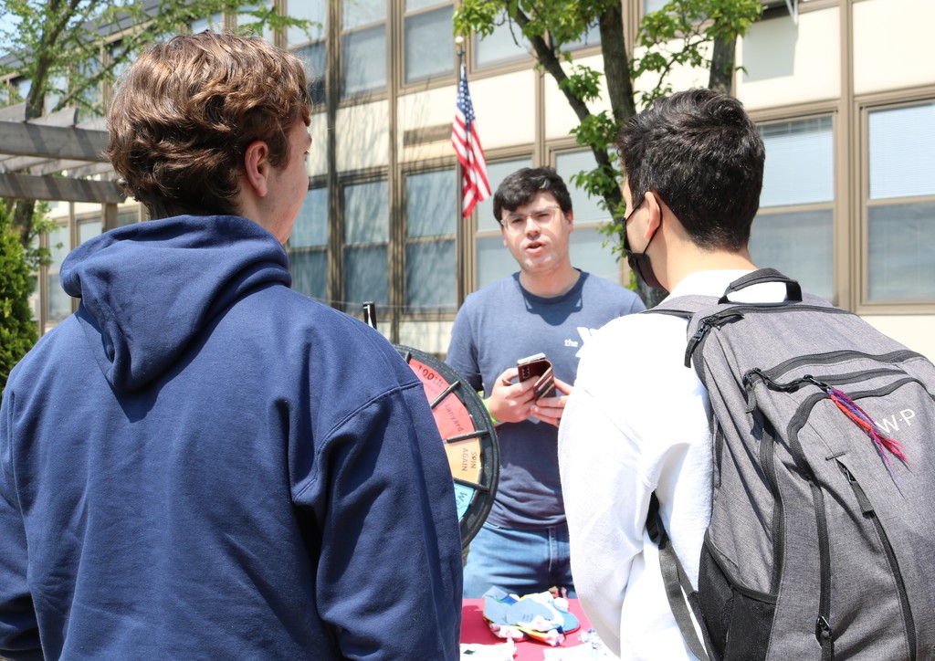 Two WHS students talk to rep at Mental Health Awareness Fair