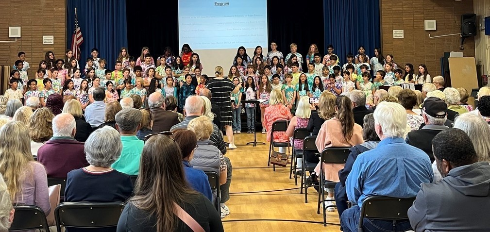 wide shot of Jefferson Grade 5 Chorus performing for special guests