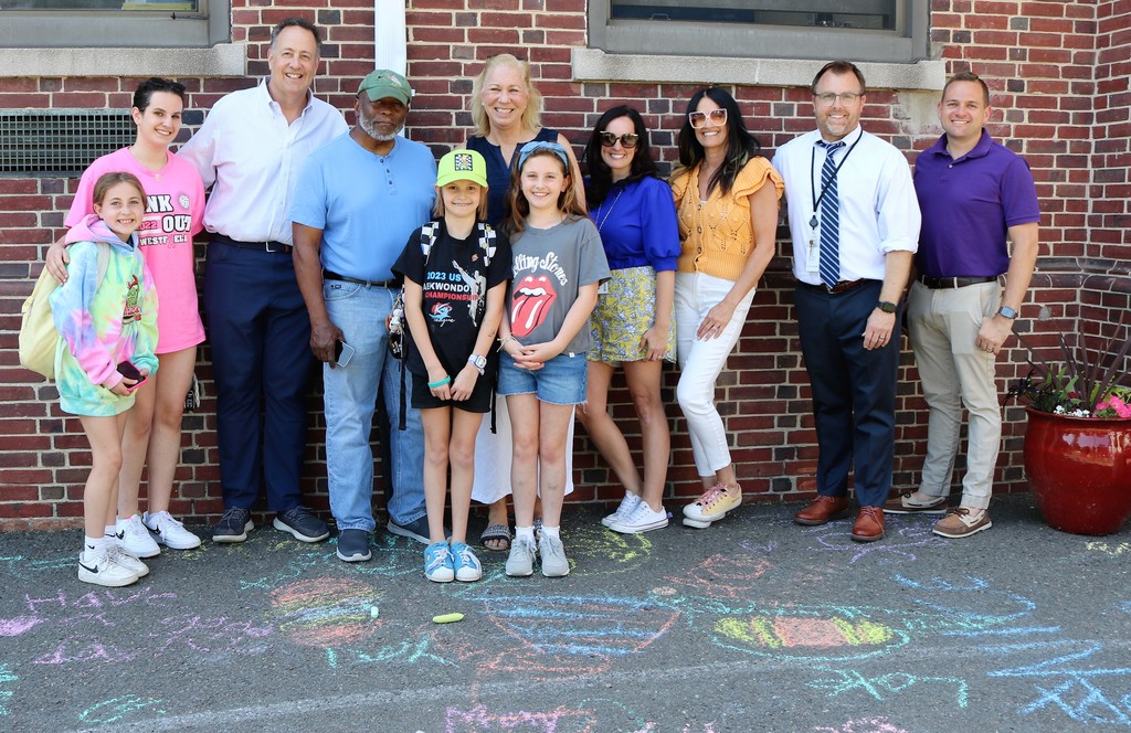Westfield mayor, Franklin principal , students and members of the Westfield Human Relations Advisory Commission pose for a picture in front of chalked messages