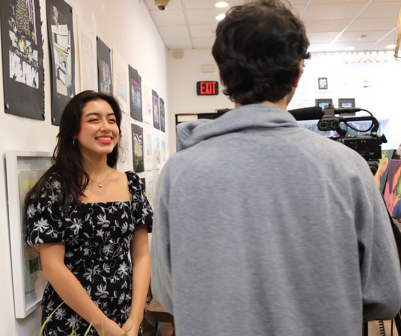 WHS 11th grader smiles as she is interviewed by student tv journalists.